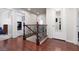 Hallway features wood floors and decorative wrought iron stair railing at 5620 Siena Rose St, North Las Vegas, NV 89031