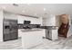 Modern kitchen with stainless steel appliances, gray backsplash, tile floors and white cabinetry at 5620 Siena Rose St, North Las Vegas, NV 89031