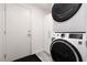 Convenient laundry area features stacked washer and dryer at 5620 Siena Rose St, North Las Vegas, NV 89031