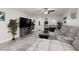 Modern living room with plush seating, stylish decor, hardwood floors and a large TV at 5620 Siena Rose St, North Las Vegas, NV 89031