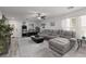 Modern living room with plush seating, stylish decor, hardwood floors and a large TV at 5620 Siena Rose St, North Las Vegas, NV 89031