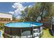 Backyard featuring an above-ground pool with a basketball hoop and ladder for hot summer days at 5620 Siena Rose St, North Las Vegas, NV 89031