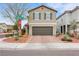 Two-story home with brick driveway, a two-car garage and well-kept landscaping at 6619 Frosted Harvest Ave, Las Vegas, NV 89108