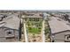 Aerial view of a community featuring a manicured common area with picnic tables and manicured landscaping at 668 Tiarella Ln, Henderson, NV 89015