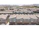 Community aerial view of townhomes with tile roofs, garages, and desert landscaping, showcasing community living at 668 Tiarella Ln, Henderson, NV 89015