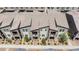 Community aerial view showcasing townhomes with private balconies, lush landscaping and beautiful surroundings at 668 Tiarella Ln, Henderson, NV 89015