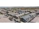 Aerial view of a community with well-maintained townhomes and lush landscaping with mountain views at 668 Tiarella Ln, Henderson, NV 89015