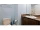 Neat bathroom featuring a vanity with a sink, toilet, and a large mirror for added convenience at 668 Tiarella Ln, Henderson, NV 89015