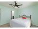 Cozy bedroom features a ceiling fan, soft carpet, and is adjacent to a bathroom, providing privacy at 668 Tiarella Ln, Henderson, NV 89015
