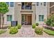 Charming townhome with a small front yard featuring decorative landscaping and a second-story balcony at 668 Tiarella Ln, Henderson, NV 89015