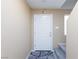 Hallway near stairway featuring a landing and an exterior door with access to natural light at 668 Tiarella Ln, Henderson, NV 89015