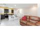 Bright kitchen with granite countertops, stainless steel appliances, and a cozy brown sofa at 668 Tiarella Ln, Henderson, NV 89015