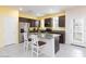 Open kitchen featuring stainless steel appliances, granite countertops, and breakfast bar seating at 668 Tiarella Ln, Henderson, NV 89015