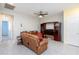 Comfortable living room featuring tile floors, a ceiling fan, and a cozy brown leather sofa at 668 Tiarella Ln, Henderson, NV 89015