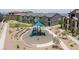 Well-maintained community playground with a blue slide, benches, and gravel ground cover, perfect for to play at 668 Tiarella Ln, Henderson, NV 89015