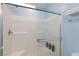 Clean and modern shower with tiled walls, a built-in seat, and a sleek glass door at 668 Tiarella Ln, Henderson, NV 89015