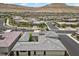 An aerial view of the home showcasing the landscaping, tile roof and mountain views at 6804 Regency Stone Way, Las Vegas, NV 89148
