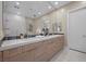 Elegant bathroom features dual sinks, stone countertops, a large mirror, and contemporary fixtures at 6804 Regency Stone Way, Las Vegas, NV 89148