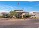 View of community clubhouse with American flag and ample parking at 6804 Regency Stone Way, Las Vegas, NV 89148