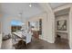 Elegant dining room with modern lighting, ample seating, hardwood floors, and a view to the backyard at 6804 Regency Stone Way, Las Vegas, NV 89148