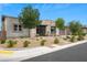 This single-story home features a stone exterior, desert landscaping, and a two-car garage at 6804 Regency Stone Way, Las Vegas, NV 89148