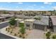 A beautiful front exterior featuring stone accents, a paver driveway and desert landscaping at 6804 Regency Stone Way, Las Vegas, NV 89148