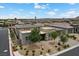 A beautiful front exterior featuring stone accents, a paver driveway and desert landscaping at 6804 Regency Stone Way, Las Vegas, NV 89148