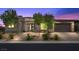 Modern home's exterior with stone accents, desert landscaping, and decorative steel front gate at 6804 Regency Stone Way, Las Vegas, NV 89148