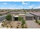A beautiful front exterior featuring stone accents, a paver driveway and desert landscaping at 6804 Regency Stone Way, Las Vegas, NV 89148