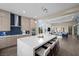 Open kitchen featuring a large island with seating, modern stainless steel appliances, and pendant lighting at 6804 Regency Stone Way, Las Vegas, NV 89148