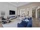 Bright living room with a linear fireplace, stylish furnishings, and a view into the kitchen at 6804 Regency Stone Way, Las Vegas, NV 89148