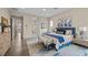 Bright main bedroom features a blue accent wall, a colorful rug and plenty of natural light at 6804 Regency Stone Way, Las Vegas, NV 89148