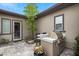 Exterior kitchen area with a grill, counter, and seating at 6804 Regency Stone Way, Las Vegas, NV 89148