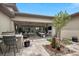 A gorgeous outdoor living space with patio seating, barbecue, and landscaping at 6804 Regency Stone Way, Las Vegas, NV 89148