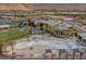 A view of the community pool with palm trees and tables, showcasing the community clubhouse at 6804 Regency Stone Way, Las Vegas, NV 89148