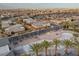 Aerial view of community pool area surrounded by lounge chairs and palm trees at 6804 Regency Stone Way, Las Vegas, NV 89148