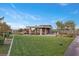 Wonderful recreation area with a covered patio, built-in grill, seating, and large manicured lawn at 6804 Regency Stone Way, Las Vegas, NV 89148