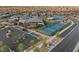 A view of the community tennis courts showcasing the community clubhouse and neighborhood at 6804 Regency Stone Way, Las Vegas, NV 89148