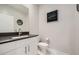 Stylish powder room featuring a modern vanity with a dark countertop and contemporary fixtures at 6834 Compass St, North Las Vegas, NV 89084