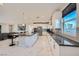 Bright, open kitchen featuring white cabinetry, granite countertops, and marble flooring at 6834 Compass St, North Las Vegas, NV 89084