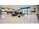 An open-concept living room and kitchen featuring elegant marble floors and plenty of natural light at 6834 Compass St, North Las Vegas, NV 89084