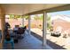 Inviting backyard with covered patio, dining set, and serene desert landscaping with a fire pit and privacy wall at 7340 Alpine Ridge St, Las Vegas, NV 89131