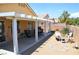 Spacious backyard with a covered patio, desert landscaping, rock features and a privacy wall at 7340 Alpine Ridge St, Las Vegas, NV 89131