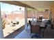 Relaxing backyard featuring a covered patio with dining, BBQ, desert landscaping and privacy wall at 7340 Alpine Ridge St, Las Vegas, NV 89131