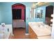 Bathroom showcasing a soaking tub, vanity area, and access to the Primary bedroom at 7340 Alpine Ridge St, Las Vegas, NV 89131