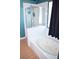Bathroom featuring a soaking tub with a shower, tile surround, and a window at 7340 Alpine Ridge St, Las Vegas, NV 89131