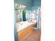 Bright bathroom featuring a vanity with ample lighting and a separate shower room at 7340 Alpine Ridge St, Las Vegas, NV 89131