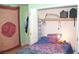 Cozy bedroom featuring a brightly colored bedspread and an organized closet with ample storage space at 7340 Alpine Ridge St, Las Vegas, NV 89131