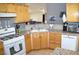 Bright eat-in kitchen featuring wooden cabinetry, stainless-steel appliances, and granite countertops at 7340 Alpine Ridge St, Las Vegas, NV 89131