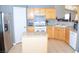 Bright eat-in kitchen featuring wooden cabinetry, stainless-steel appliances, and granite countertops at 7340 Alpine Ridge St, Las Vegas, NV 89131